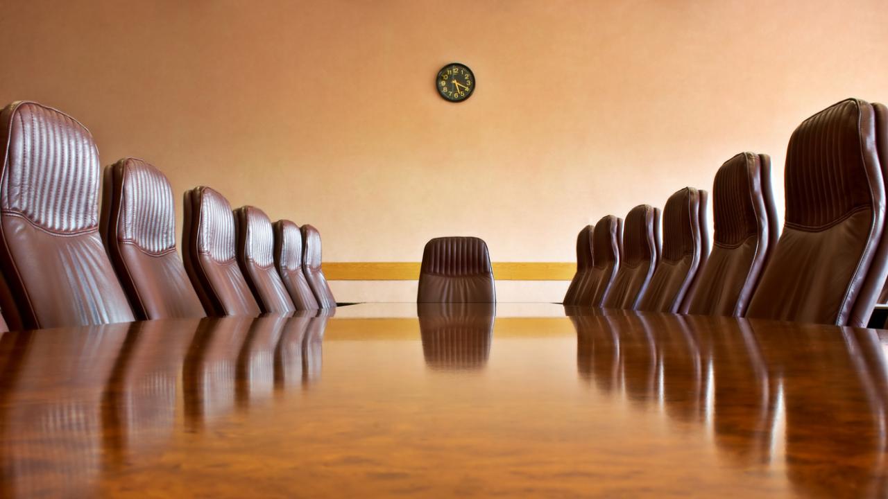 Image of a council room table, empty just before a meeting.