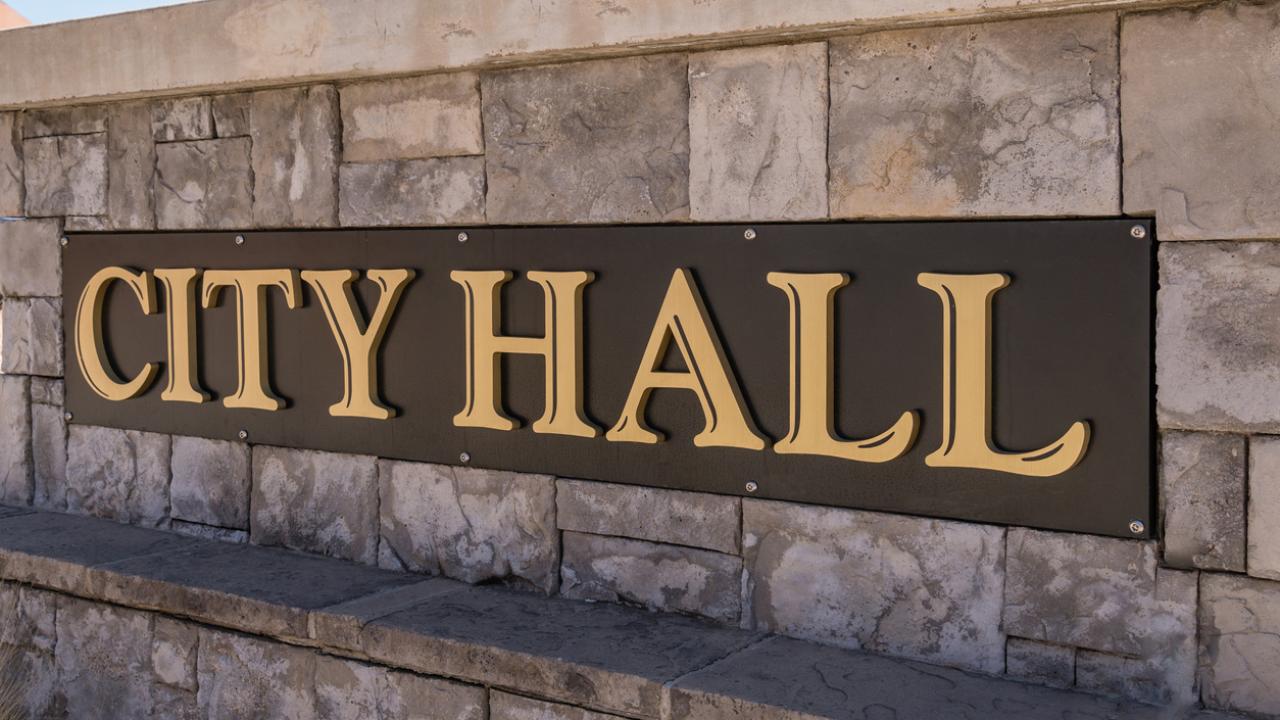 Image of a sign that says, &quot;CITY HALL.&quot;