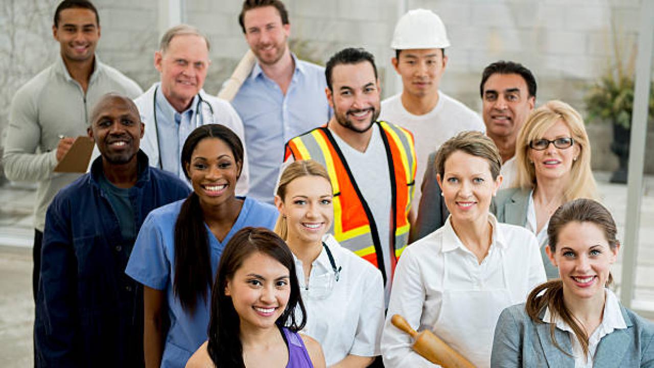 A group of state workers look up at the camera.