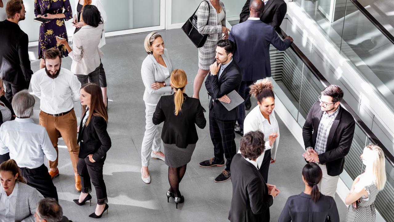 Image of a group of people mingling at a public human resources event.