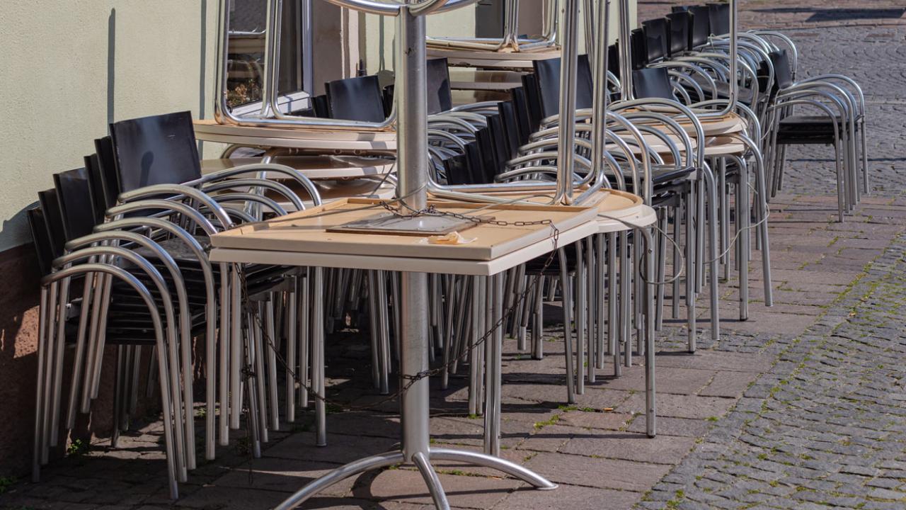 Image of surplus tables and chairs lined up against a wall.