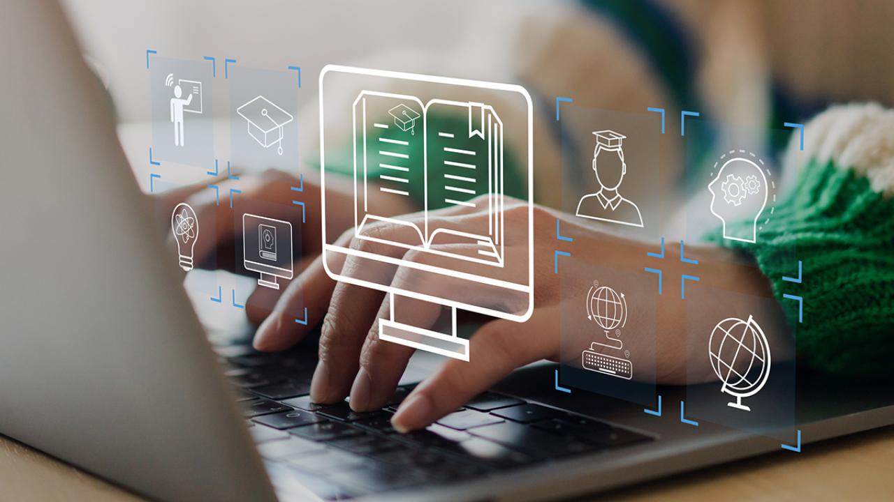 Closeup of hands on a laptop keyboard. Floating, transparent icons indicate subjects of learning.