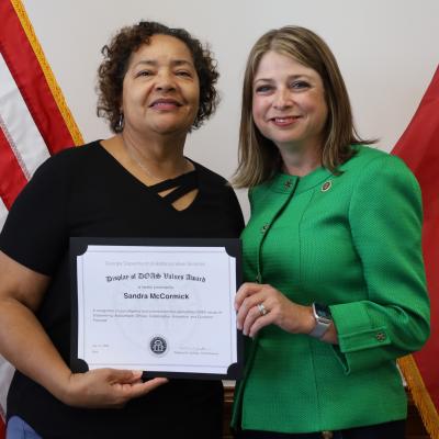 Sandra McCormick receives a Display of DOAS Values Award from Commissioner Rebecca Sullivan.