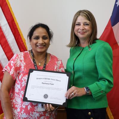 Rachana Patel receives a Display of DOAS Values Award from Commissioner Rebecca Sullivan.