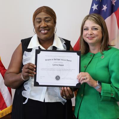 Lorna Sippo receives a Display of DOAS Values Award from Commissioner Rebecca Sullivan.
