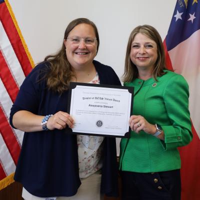 Alexandria Stewart receives a Display of DOAS Values Award from Commissioner Rebecca Sullivan.