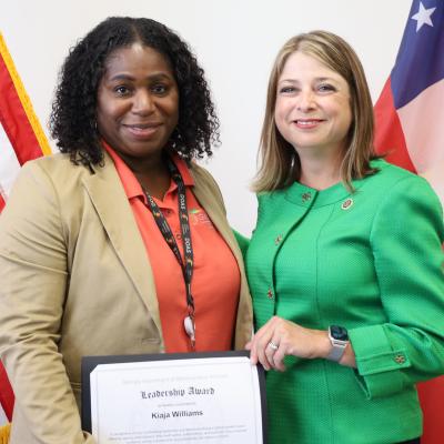 Kiaja Williams receives a Display of DOAS Values Award from Commissioner Rebecca Sullivan.