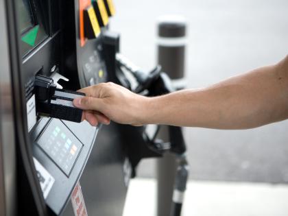 A person used a fuel card to pay at a gasoline pump.