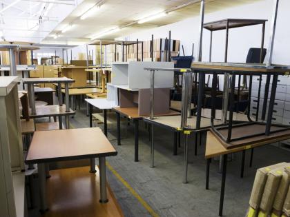 A photo of stacks of surplus office furniture. 