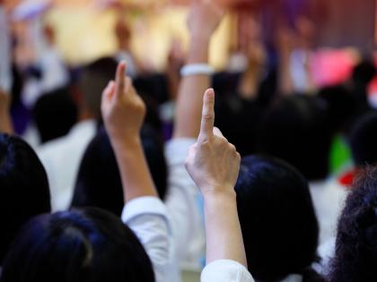An image of hands raised at an auction.