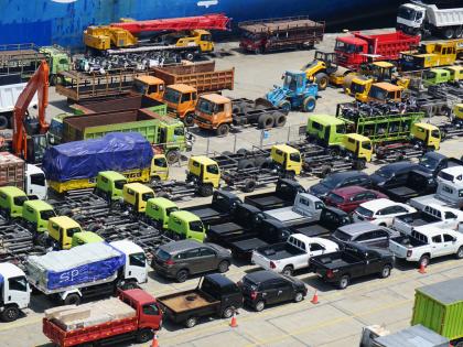 An assortment of surplus government vehicles sit idle in a storage lot. 