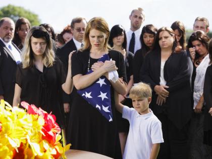 Image of a family at a funeral for a fallen officer.