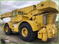 Picutre of a yellow heavy work vehicle with a crane.