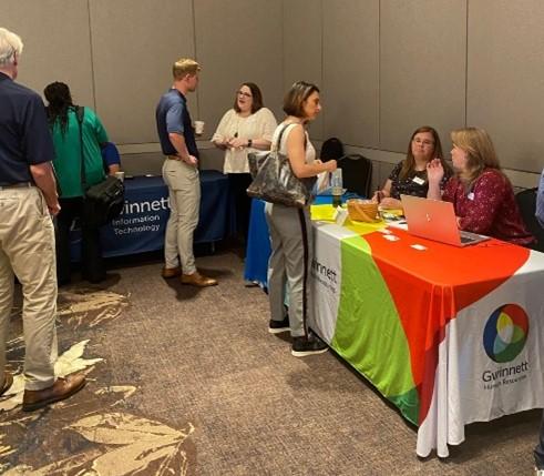 People visiting information booth at event