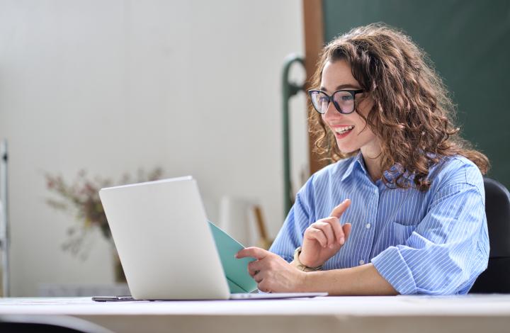 Woman gazing at laptop online learning