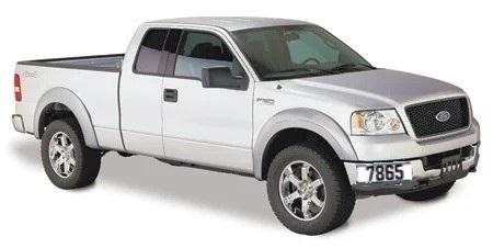 Image of a silver pickup truck as seen in profile from the passenger side. The number 7865 is displayed prominently on the passenger side of the front bumper.